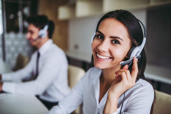 Woman smiling while using a headset.